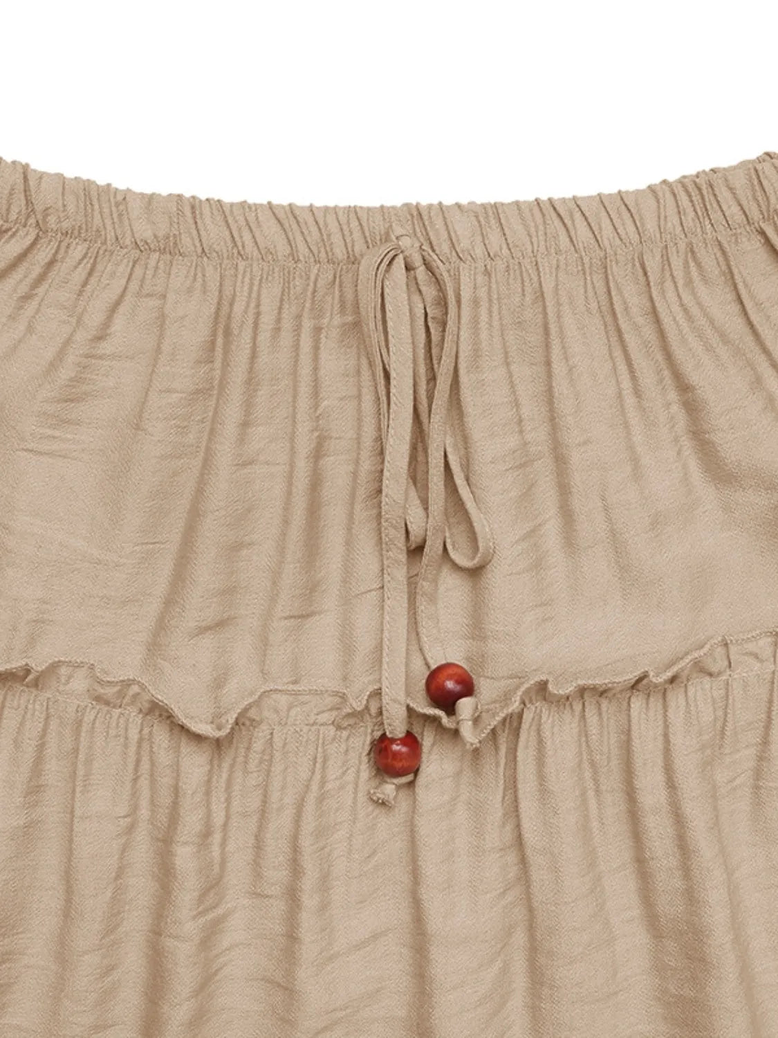 Beige skirt with red buttons on a white background