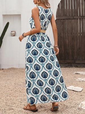 Woman wearing a blue and white patterned dress standing outdoors.