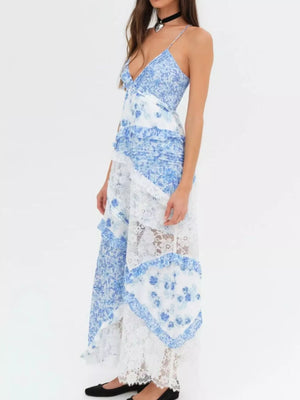 Woman wearing a blue and white floral dress on a white background