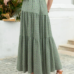 Green floral dress worn by a person standing outdoors.