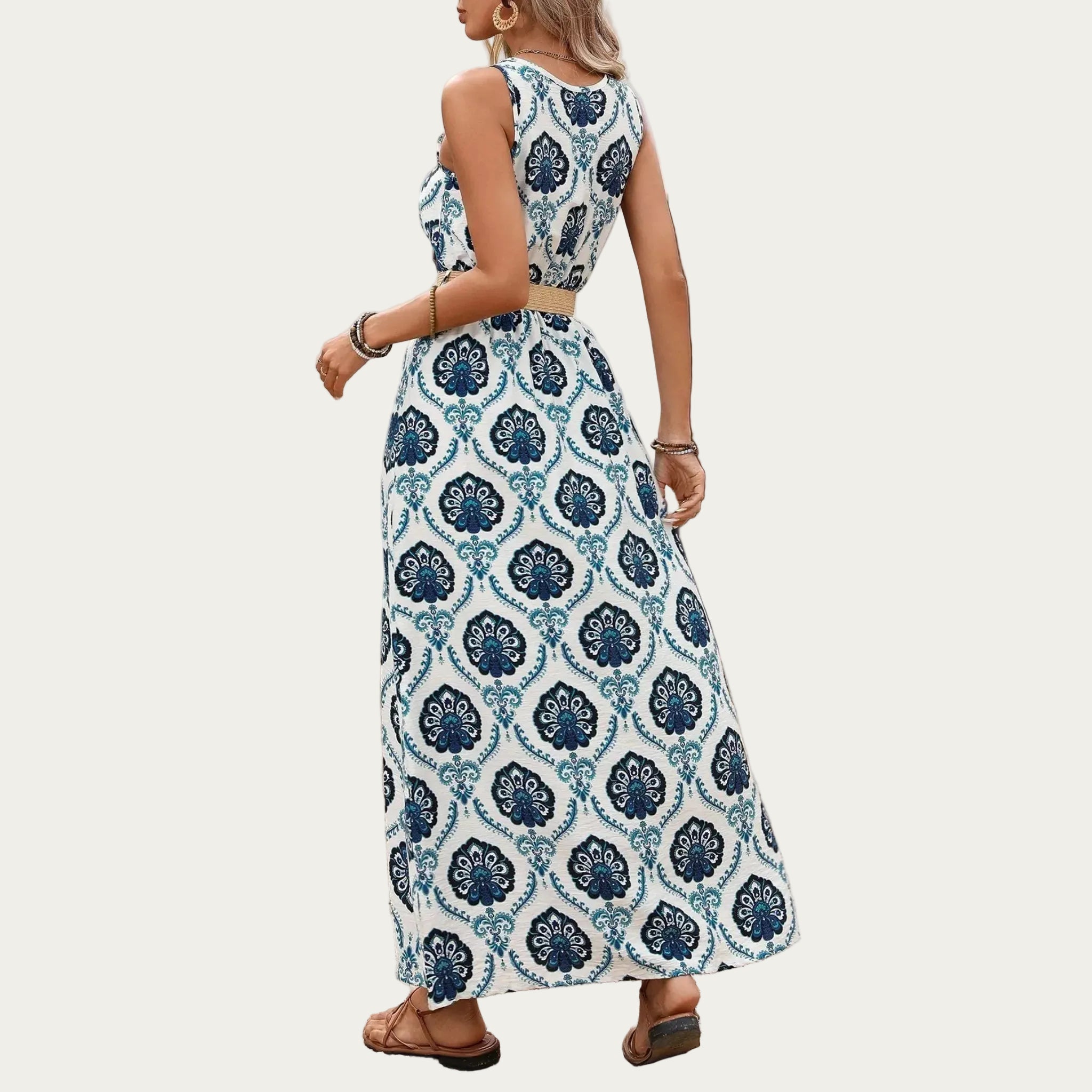 Woman wearing a blue and white patterned dress standing outdoors.