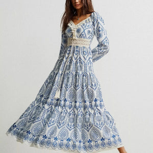 Woman wearing a blue and white patterned dress on a plain background