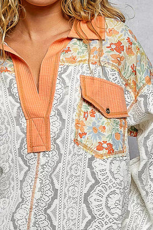 Floral patterned jacket with orange accents worn by a person