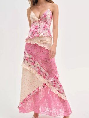 Woman wearing a pink and beige floral dress on a white background