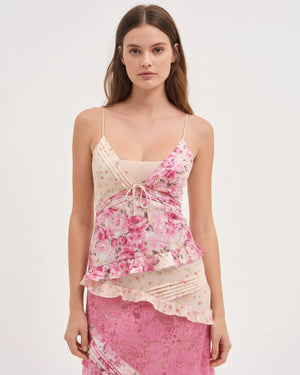 Woman wearing a pink floral dress with a white background