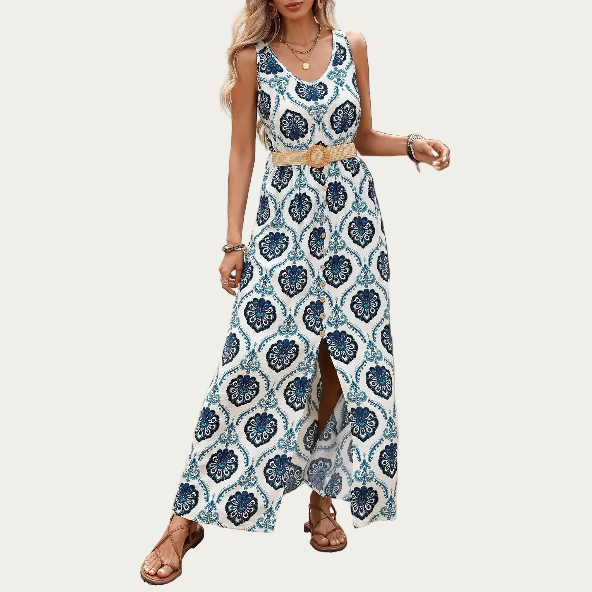 Woman wearing a long, patterned dress with a belt in an outdoor setting.