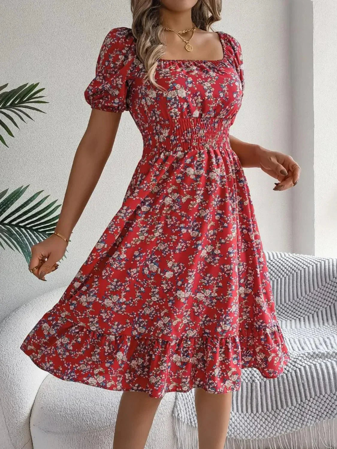 woman in red floral dress with square neck and ruffled hem flowy knee-length dress