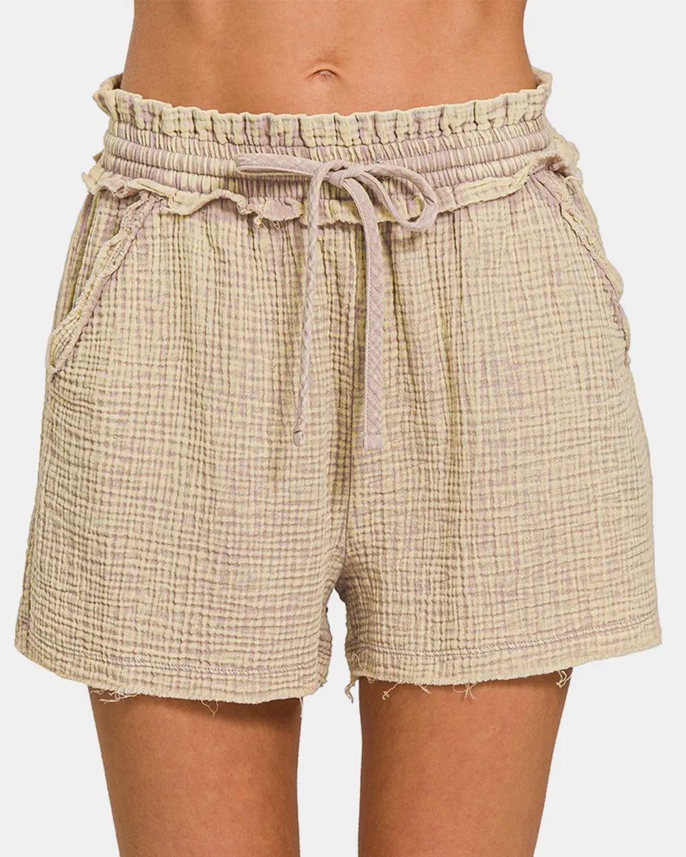 Beige plaid shorts with a drawstring waist on a white background