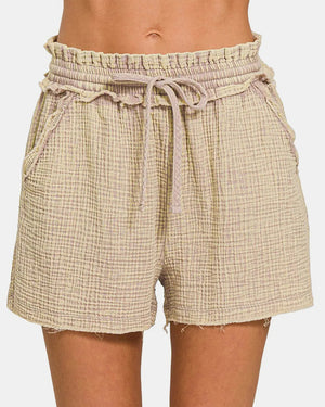 Beige plaid shorts with a drawstring waist on a white background