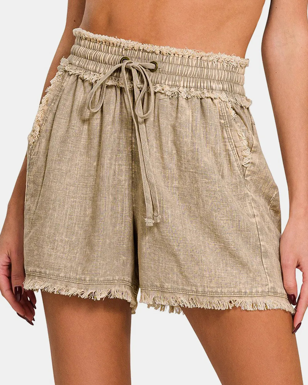 Beige shorts with a tie waist on a white background