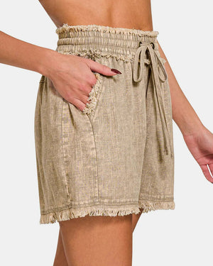 Beige linen skirt with a tie waist on a white background