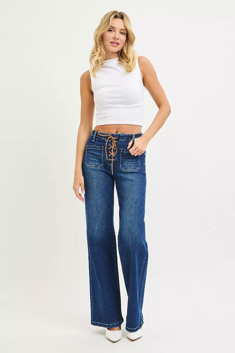 Woman wearing blue jeans and a white top on a white background