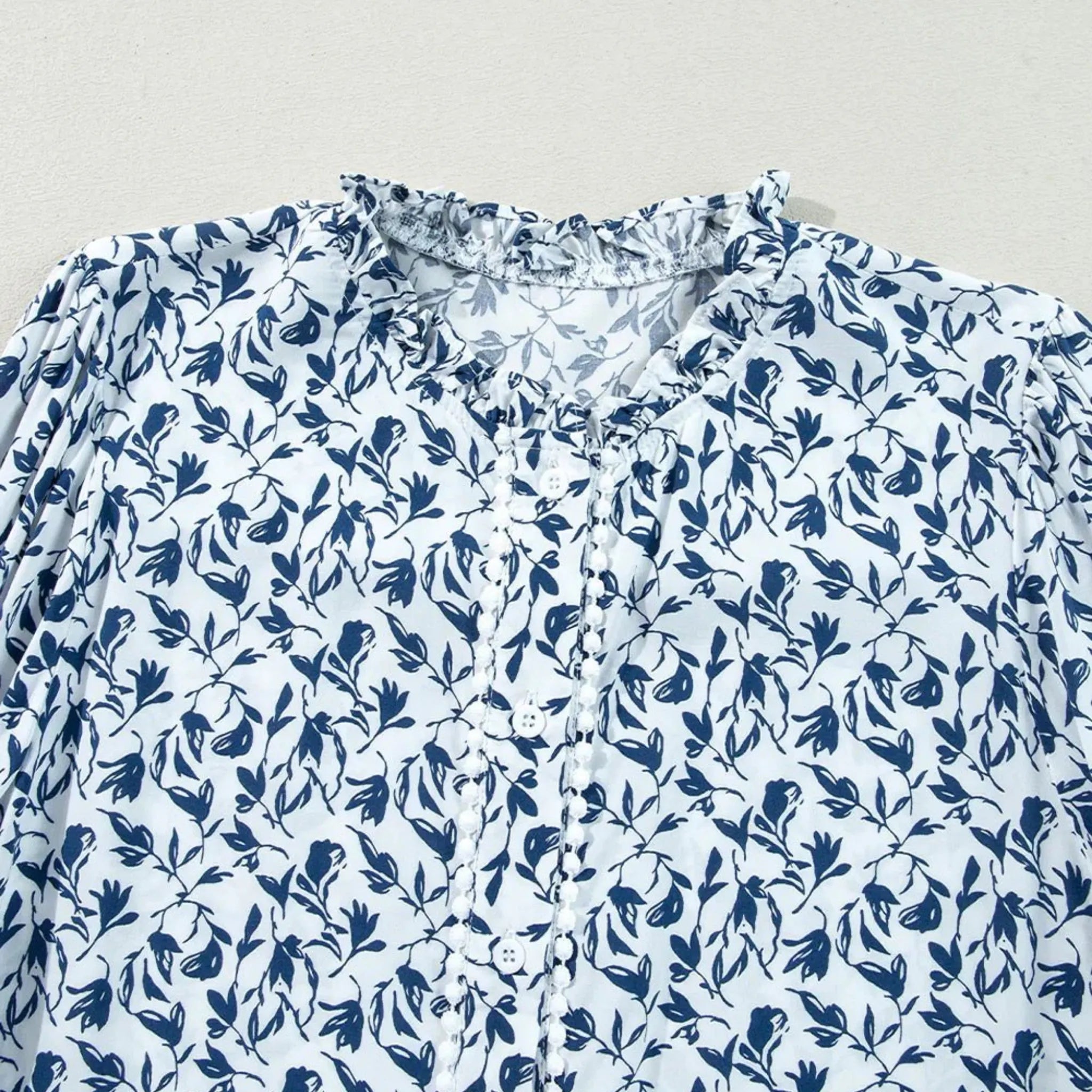 Blue floral pattern on a light blue fabric background