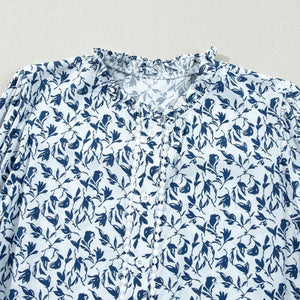 Blue floral pattern on a light blue fabric background