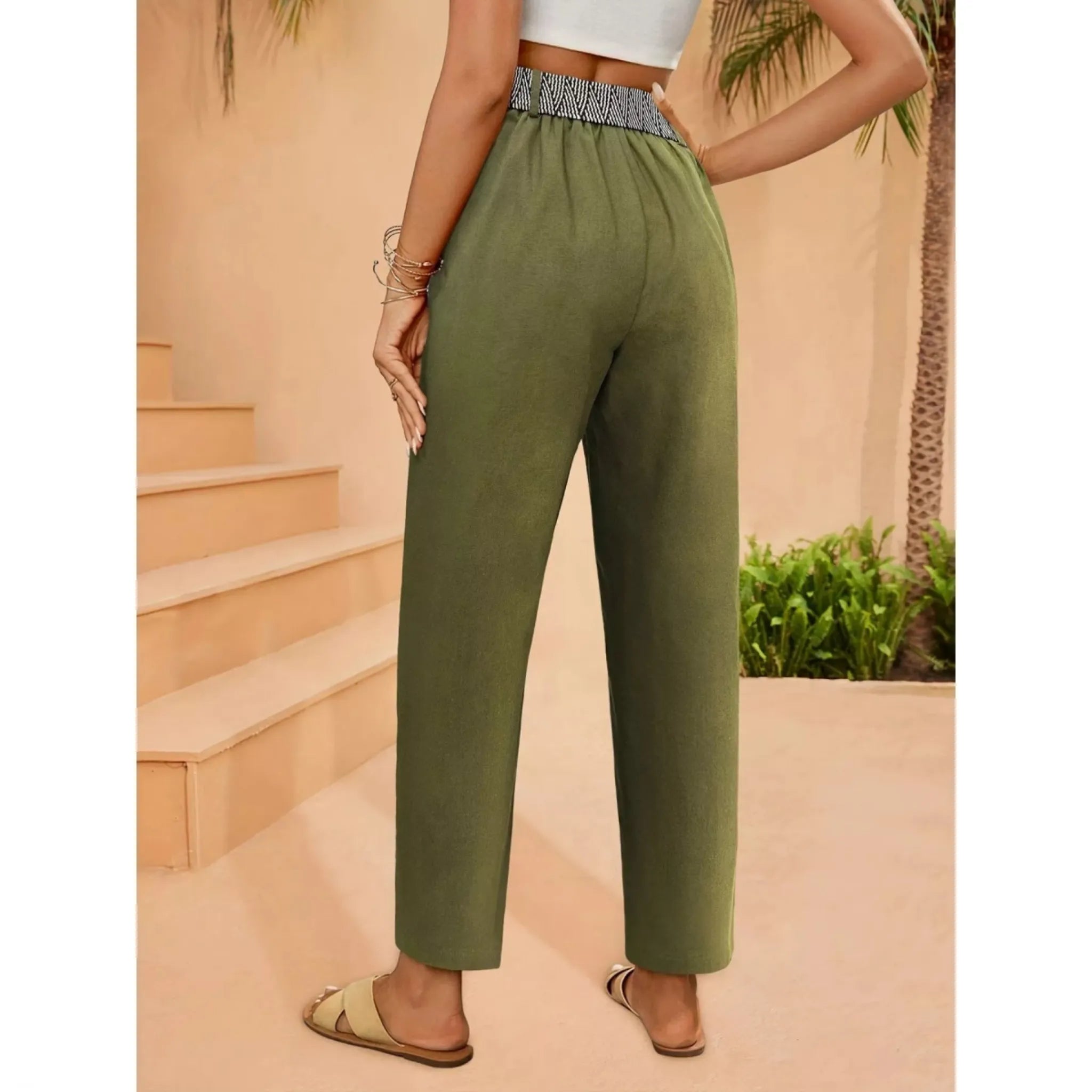 Person wearing green pants standing on a staircase with a blurred background