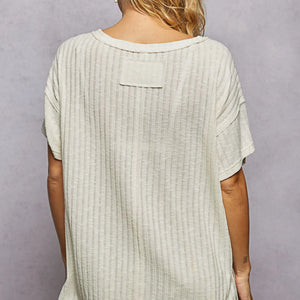 Light green textured top worn by a person on a plain background