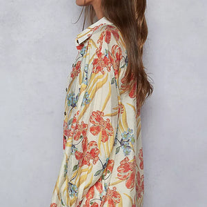 Woman wearing a floral dress with a plain background