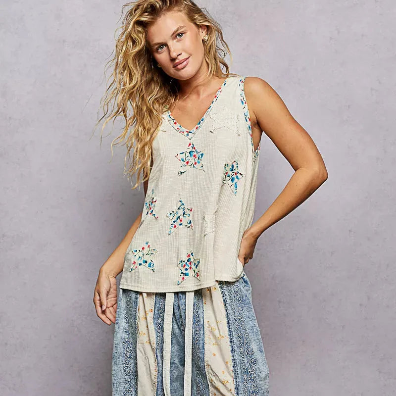 woman in beige tank top with red and blue stars and red and blue accents